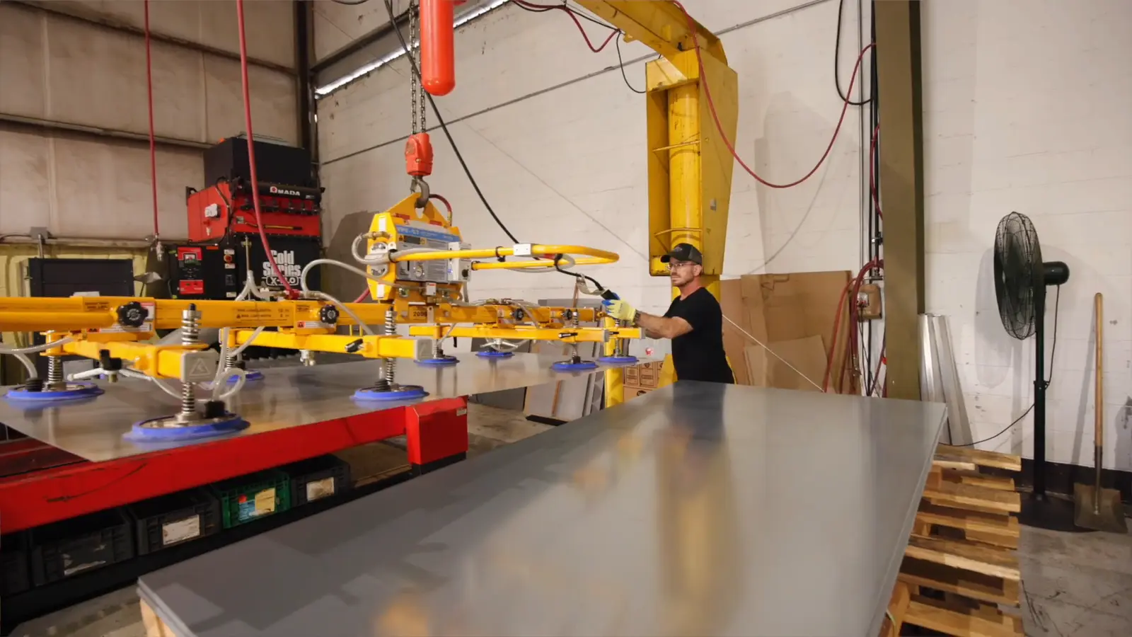 Vacuum lift moving a full sheet of steel across the Evans production floor