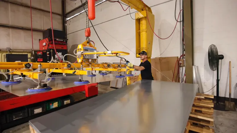 Vacuum lift moving a full sheet of steel across the Evans production floor