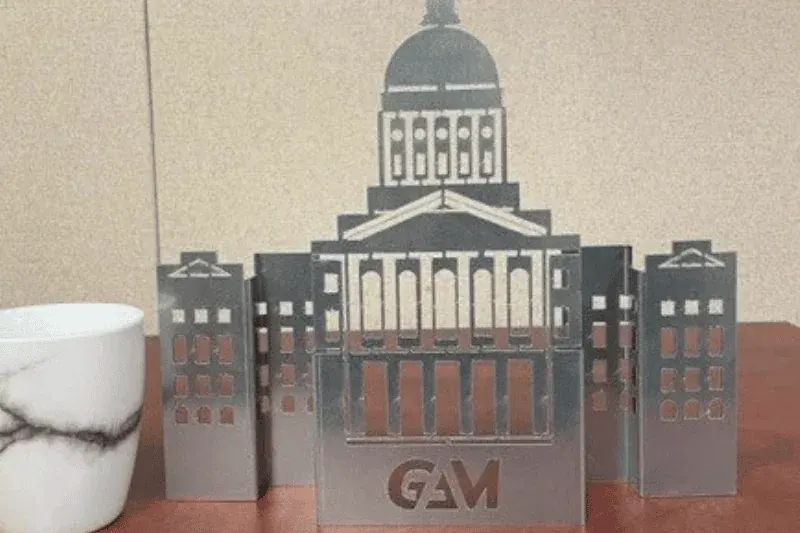 Laser-cut branded metal decor
