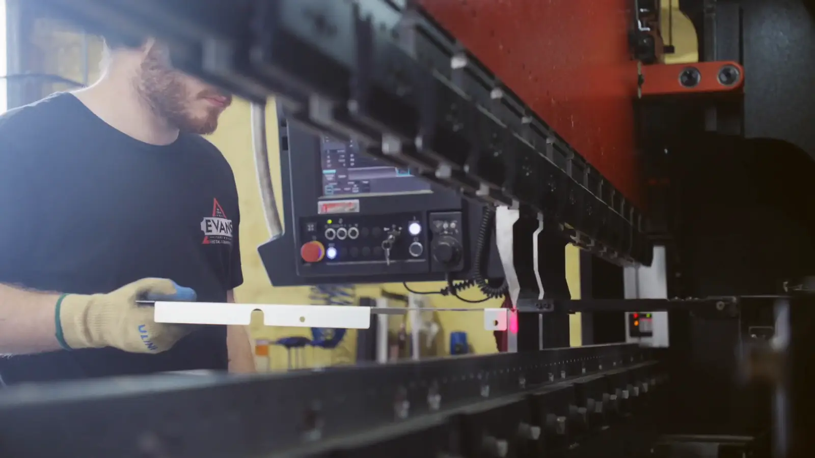 Evans operator bending sheet metal on the 110-ton press brake