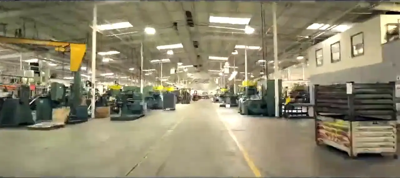 Rows of stamping presses running down the length of the Evans production floor