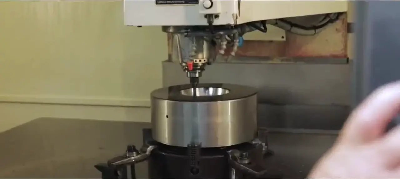 CNC machining center cutting a precision steel die in the Evans tool room