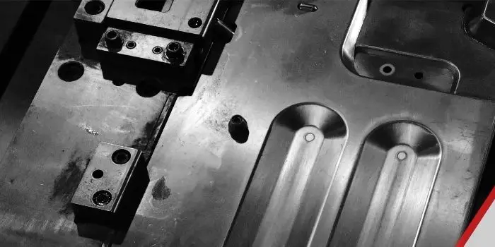 Close-up of a precision progressive die built in-house at Evans